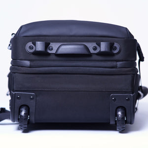 Bottom view of the MEGABACK Trolley Vacuum Backpack showing two wheels and stands.